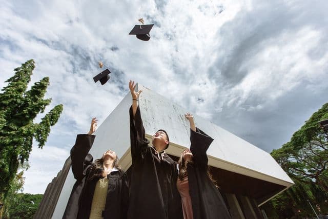 Graduates celebrating at a university graduation ceremony