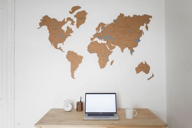 Laptop displaying a world map on a desk, symbolising research into study abroad destinations
