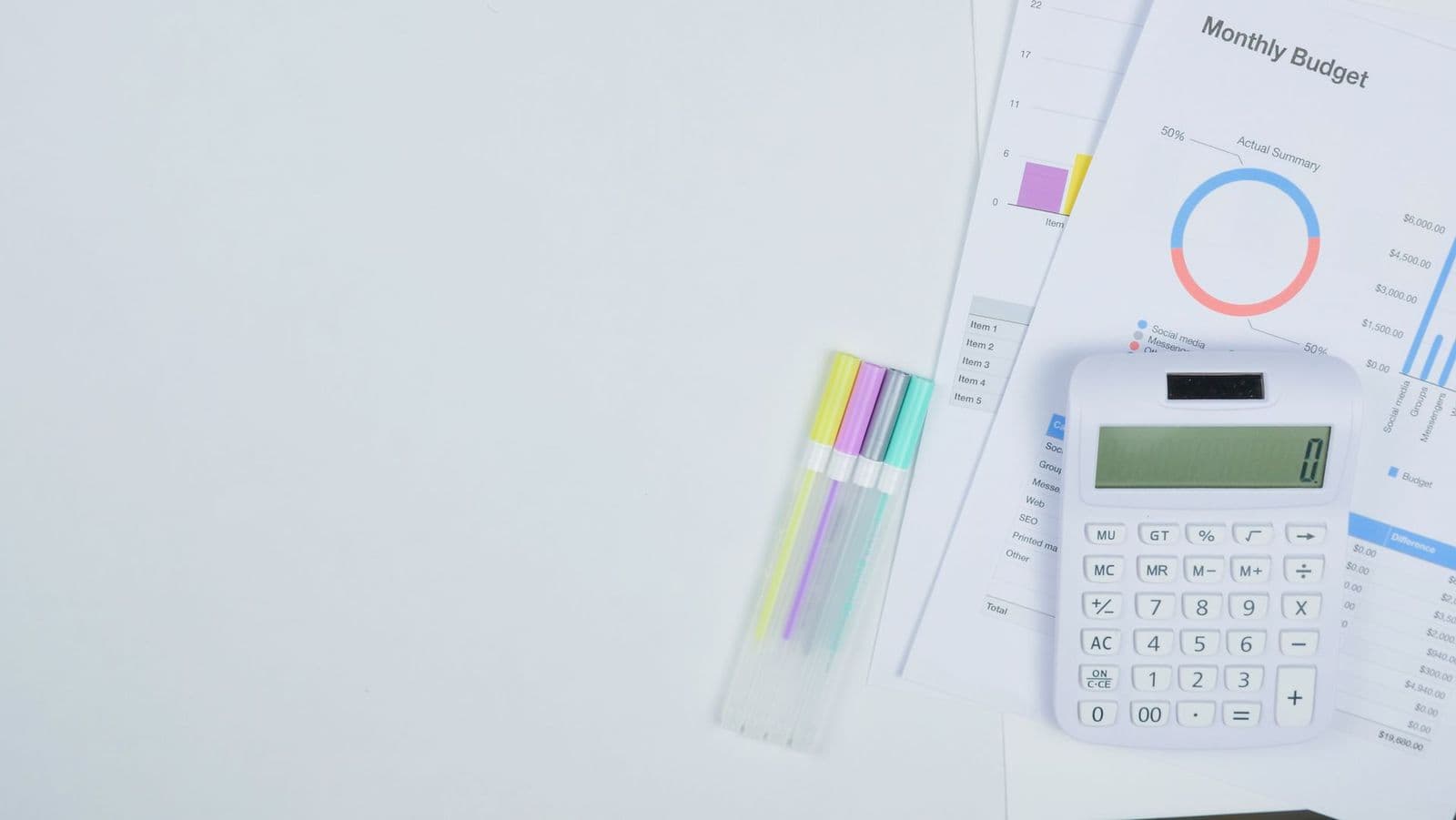 Calculator and budget planning documents on a desk, representing the cost of studying abroad